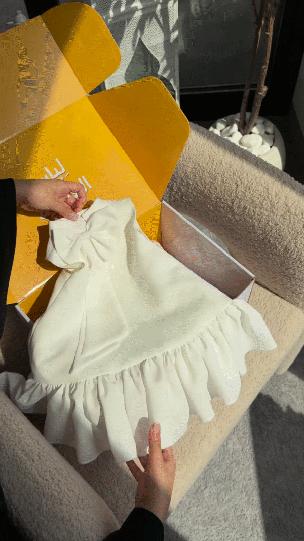 Elegant White Dress with Ruffled Hem and Bow Detail - Image 2